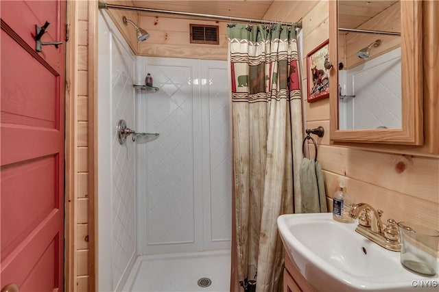 bathroom with a shower stall and vanity