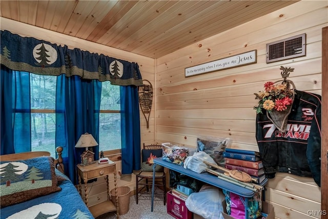 bedroom with wood ceiling and wood walls