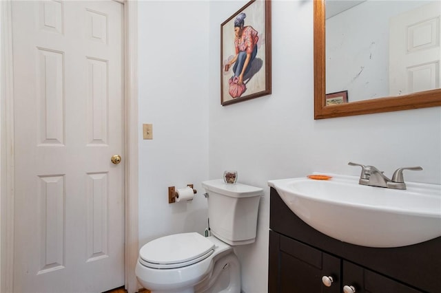 half bathroom featuring toilet and vanity