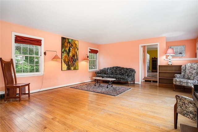 living area featuring hardwood / wood-style floors, healthy amount of natural light, and baseboards