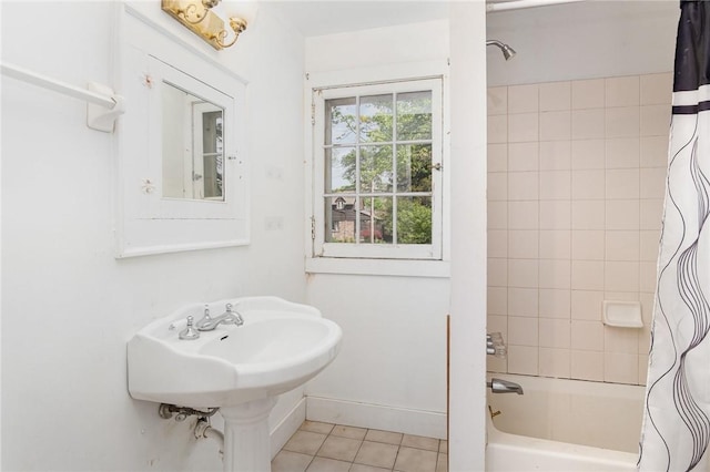 bathroom with tile patterned flooring, shower / bath combo, and baseboards
