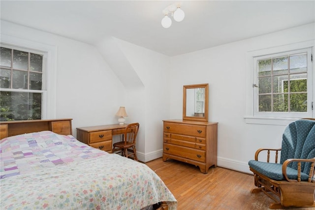 bedroom with baseboards and light wood-style floors