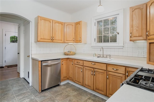 kitchen featuring stainless steel dishwasher, a sink, arched walkways, decorative backsplash, and light countertops