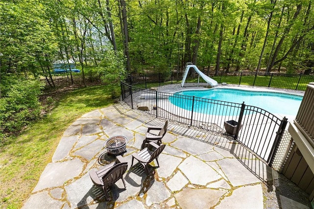 7 Mount View Cres, Penfield, NY 14580 - view of swimming pool featuring a water slide, a fire pit, and a patio area
