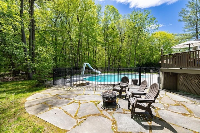 7 Mount View Cres, Penfield, NY 14580 - view of swimming pool with a water slide, an outdoor fire pit, and a patio area