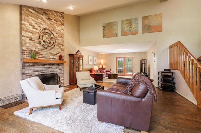 7 Mount View Cres, Penfield, NY 14580 - living area with a high ceiling, wood finished floors, stairs, and a fireplace