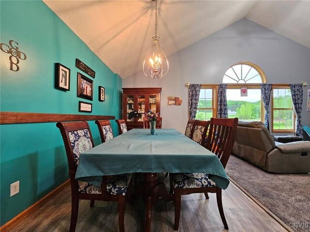437 Nye Rd, Virgil, NY 13045 - dining room with a chandelier, vaulted ceiling, and wood finished floors