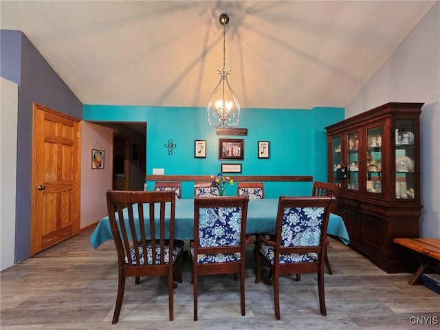437 Nye Rd, Virgil, NY 13045 - dining area featuring a chandelier, vaulted ceiling, and wood finished floors