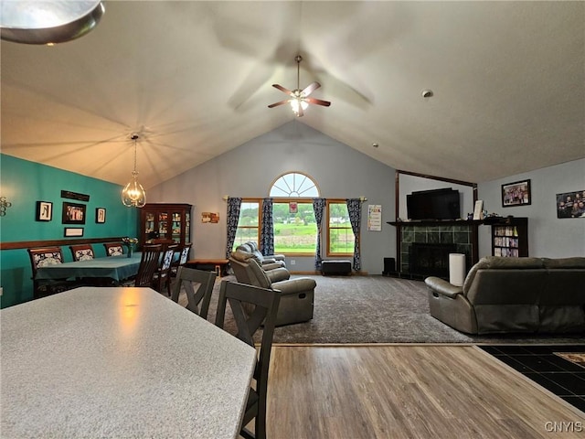 437 Nye Rd, Virgil, NY 13045 - living area featuring a ceiling fan, lofted ceiling, a tile fireplace, and wood finished floors