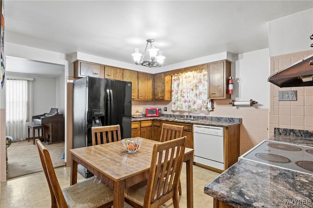 152 Nicholson St, Buffalo, NY 14216 - kitchen featuring dishwasher, brown cabinetry, dark countertops, and a chandelier