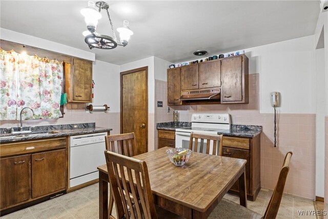 152 Nicholson St, Buffalo, NY 14216 - kitchen featuring white appliances, under cabinet range hood, a sink, tile walls, and a chandelier