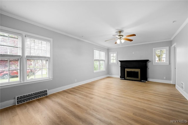 unfurnished living room with ornamental molding, a ceiling fan, a fireplace, light wood-style floors, and baseboards