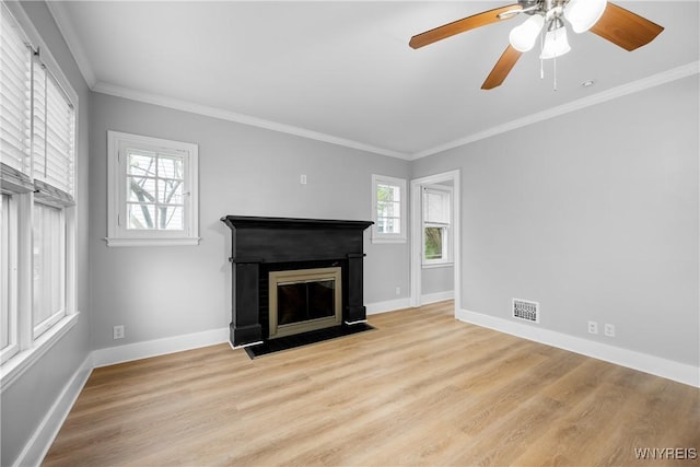 unfurnished living room with a fireplace with flush hearth, light wood-style floors, baseboards, and ornamental molding