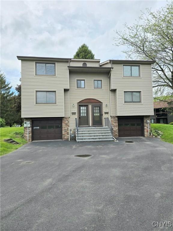 332 Cameco Cir, Salina, NY 13090 - view of front of property featuring an attached garage, driveway, and stone siding
