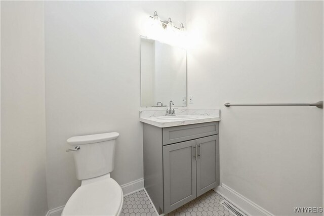 249 E St, Buffalo, NY 14207 - half bath with toilet, tile patterned flooring, baseboards, and vanity