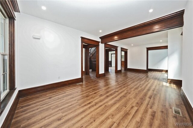249 E St, Buffalo, NY 14207 - unfurnished living room with wood finished floors, baseboards, and recessed lighting