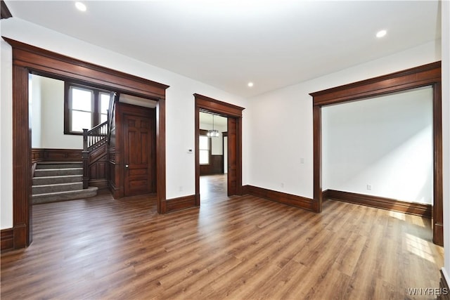 249 E St, Buffalo, NY 14207 - empty room with baseboards, wood finished floors, recessed lighting, and stairway