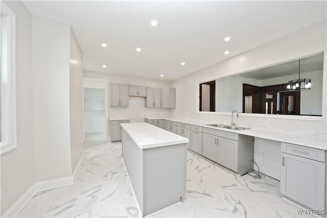 249 E St, Buffalo, NY 14207 - kitchen featuring gray cabinetry, a sink, light marble finish floors, recessed lighting, and baseboards