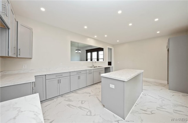 249 E St, Buffalo, NY 14207 - kitchen featuring gray cabinetry, a sink, recessed lighting, light marble finish flooring, and a kitchen island