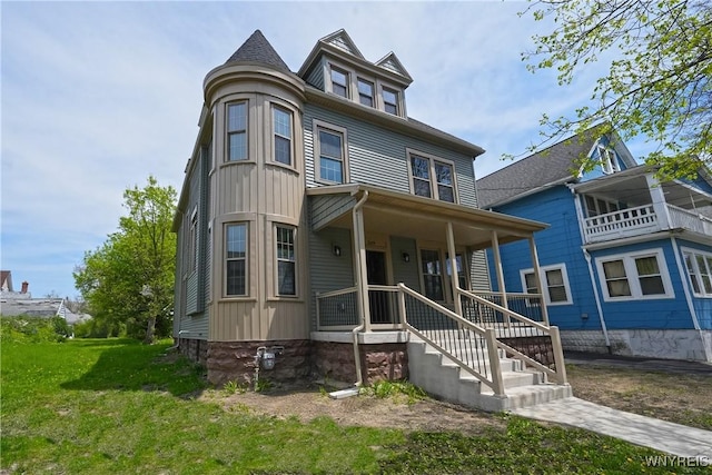 249 E St, Buffalo, NY 14207 - victorian-style house featuring a porch, a front lawn, and board and batten siding