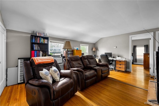 living room with an office area, lofted ceiling, and light wood-type flooring
