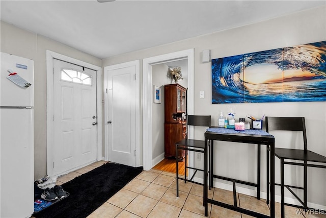 tiled entryway featuring baseboards