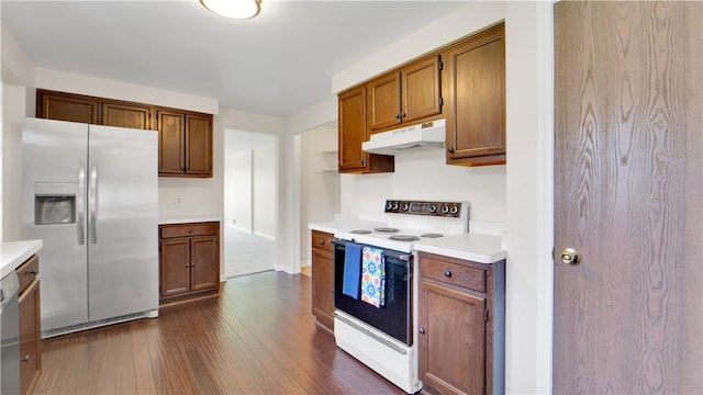 85 Kalyna Dr, Irondequoit, NY 14617 - kitchen with stainless steel appliances, under cabinet range hood, dark wood finished floors, light countertops, and brown cabinetry