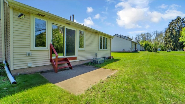 85 Kalyna Dr, Irondequoit, NY 14617 - view of green lawn featuring entry steps, cooling unit, and a patio
