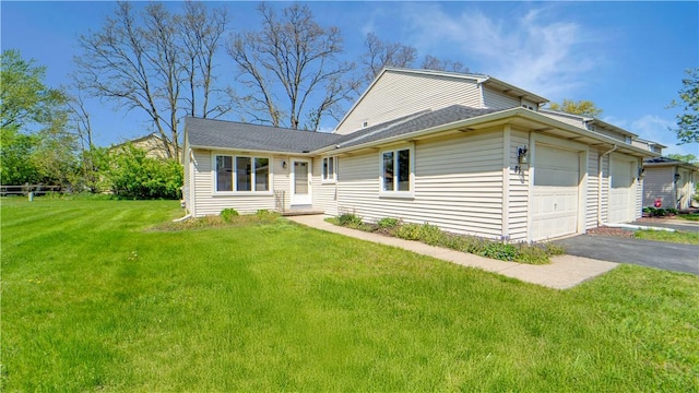85 Kalyna Dr, Irondequoit, NY 14617 - view of front of house featuring an attached garage, asphalt driveway, and a front yard