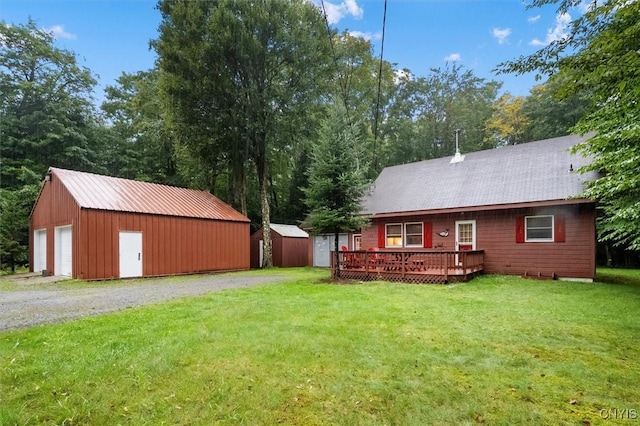 143 Thibado Rd, Webb, NY 13331 - view of green lawn with a wooden deck and a garage