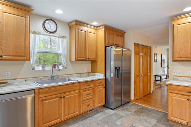 301 Silverstone Rd, Russia, NY 13438 - kitchen with stainless steel appliances, a sink, light stone counters, recessed lighting, and light stone finish flooring