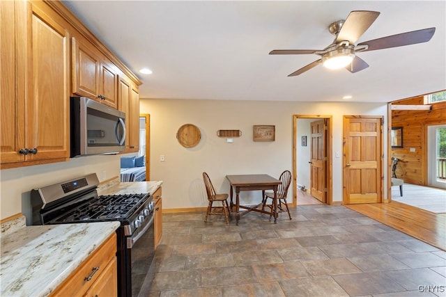 301 Silverstone Rd, Russia, NY 13438 - kitchen featuring stainless steel appliances, baseboards, ceiling fan, recessed lighting, and light stone counters