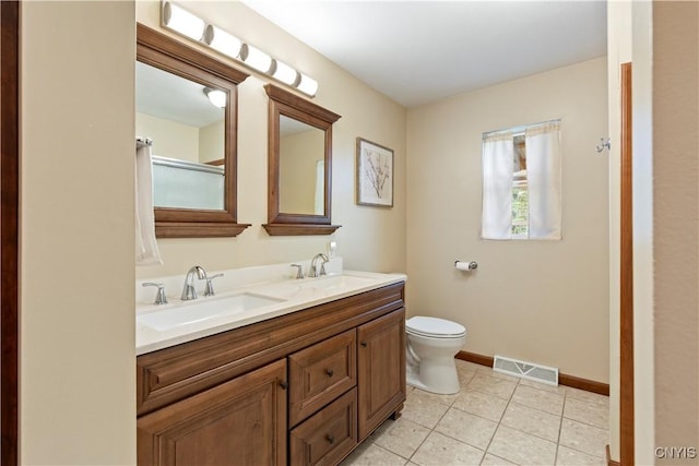 301 Silverstone Rd, Russia, NY 13438 - full bathroom featuring baseboards, toilet, double vanity, and tile patterned flooring