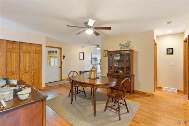 301 Silverstone Rd, Russia, NY 13438 - dining room with a ceiling fan, light wood finished floors, and baseboards