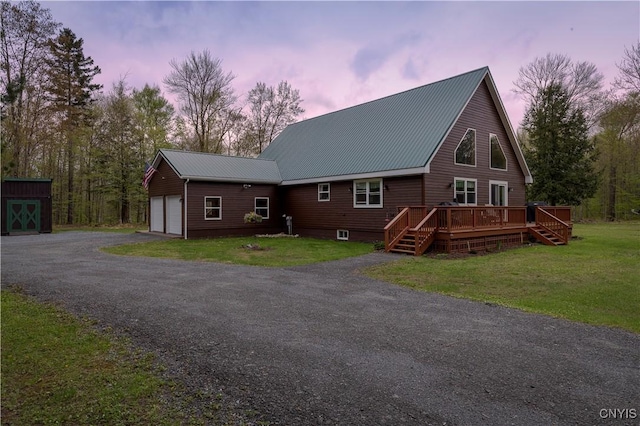 301 Silverstone Rd, Russia, NY 13438 - view of front of house with a yard, metal roof, a deck, a storage shed, and an attached garage