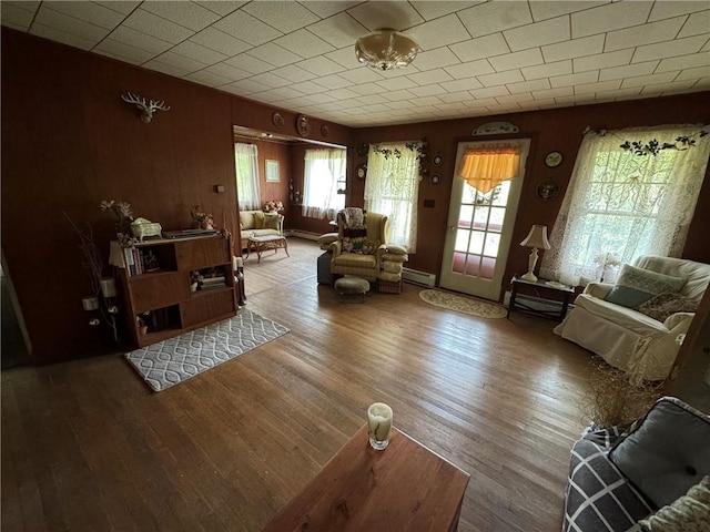 3645 County Highway 12, Kortright, NY 13739 - living area with wood finished floors, a baseboard heating unit, and wooden walls
