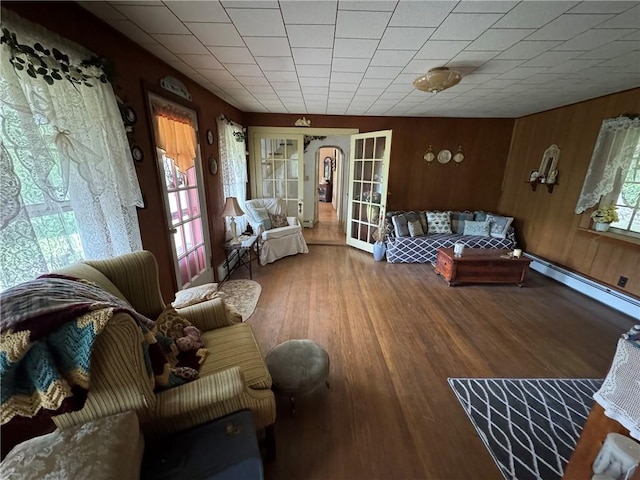 3645 County Highway 12, Kortright, NY 13739 - living room with wood finished floors, baseboard heating, wood walls, and french doors