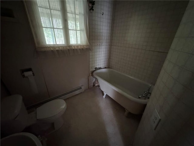 3645 County Highway 12, Kortright, NY 13739 - full bath featuring toilet, a freestanding tub, and tile walls