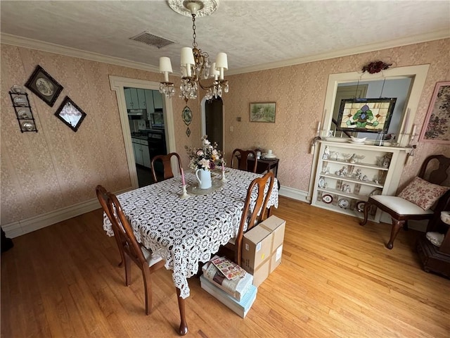 3645 County Highway 12, Kortright, NY 13739 - dining space with wood-type flooring, a chandelier, wallpapered walls, crown molding, and baseboards