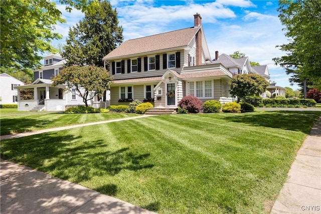 457 Broad St, Oneida-Inside, NY 13421 - view of front of home featuring a front yard and a chimney