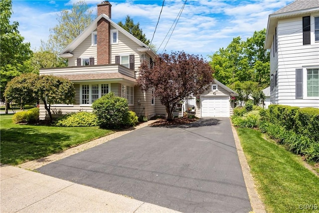457 Broad St, Oneida-Inside, NY 13421 - traditional-style house with an outdoor structure, asphalt driveway, a chimney, and a front yard