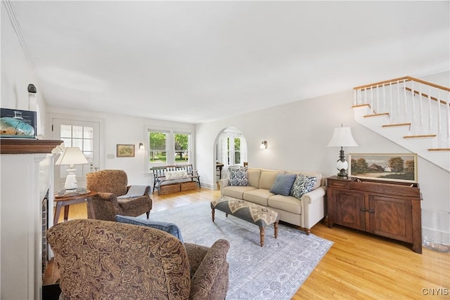 457 Broad St, Oneida-Inside, NY 13421 - living area featuring arched walkways, light wood-type flooring, and stairs