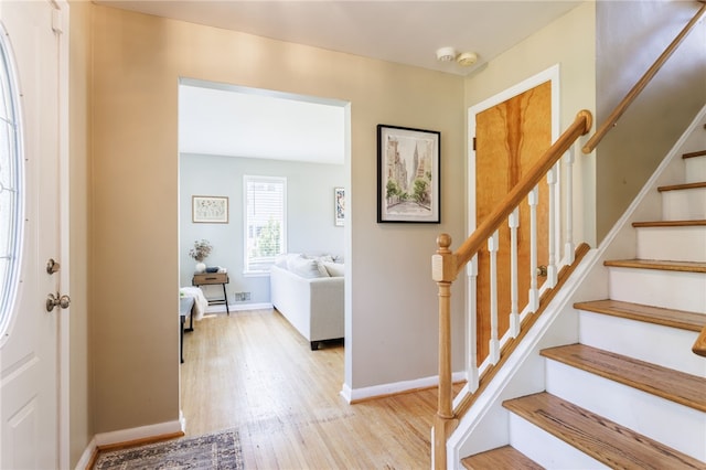 111 Barlow Dr, Greece, NY 14626 - entrance foyer featuring wood finished floors, stairs, and baseboards