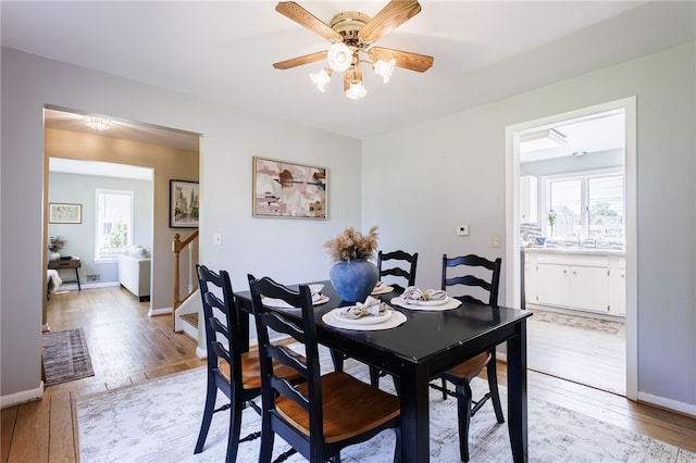 111 Barlow Dr, Greece, NY 14626 - dining room with light wood finished floors, ceiling fan, and baseboards