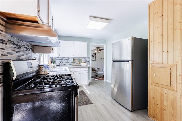 111 Barlow Dr, Greece, NY 14626 - kitchen with appliances with stainless steel finishes, under cabinet range hood, light wood finished floors, decorative backsplash, and light countertops
