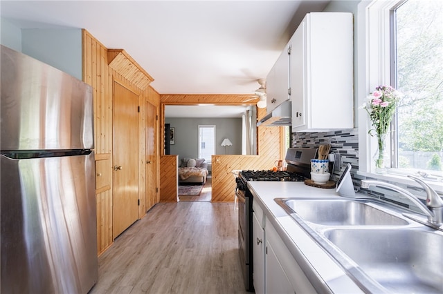 111 Barlow Dr, Greece, NY 14626 - kitchen featuring stainless steel appliances, a sink, ventilation hood, light wood-type flooring, and light countertops