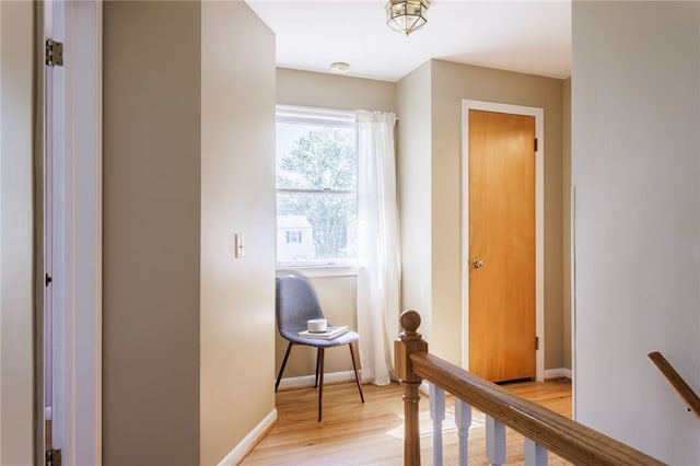 111 Barlow Dr, Greece, NY 14626 - hallway with an upstairs landing, light wood-type flooring, and baseboards