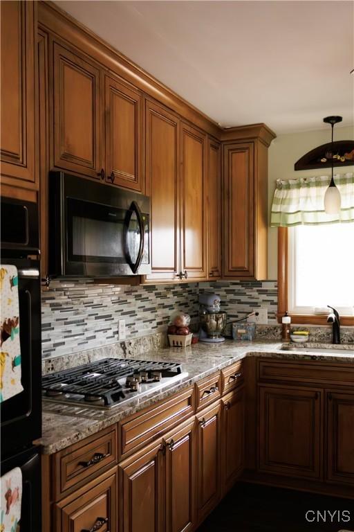 95 Briarcliff Dr, Veteran, NY 14845 - kitchen with black appliances, a sink, decorative backsplash, and stone countertops
