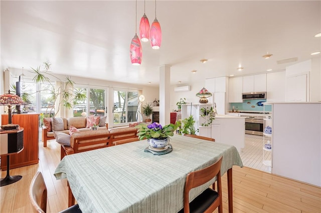 8508 Wickham Blvd, Sodus, NY 14555 - dining area featuring a wall mounted air conditioner, light wood-type flooring, and recessed lighting