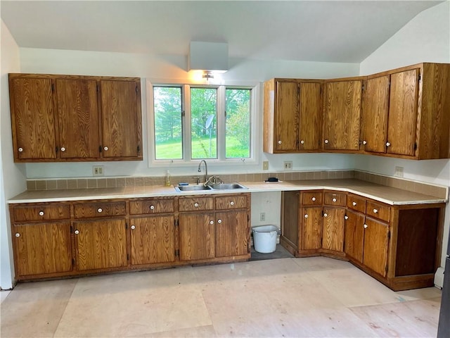 376 Upper Dutch Hill Rd, Milford, NY 13820 - kitchen featuring a sink, brown cabinets, vaulted ceiling, and light countertops
